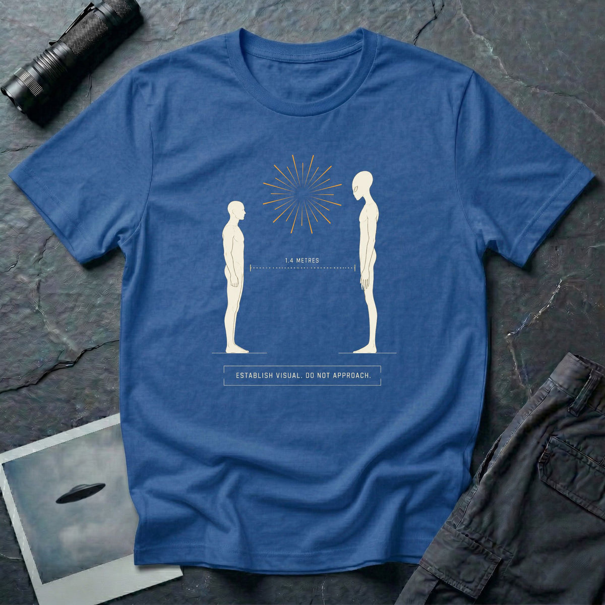 Royal blue t-shirt with human and alien figures facing each other at a measured 1.4 metre distance under a starburst, with establish visual do not approach caption