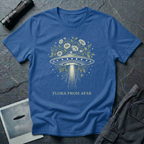 Flora From Afar botanical UFO t-shirt — Victorian-style flying saucer overgrown with flowers and vines in cream line-work on blue cotton tee