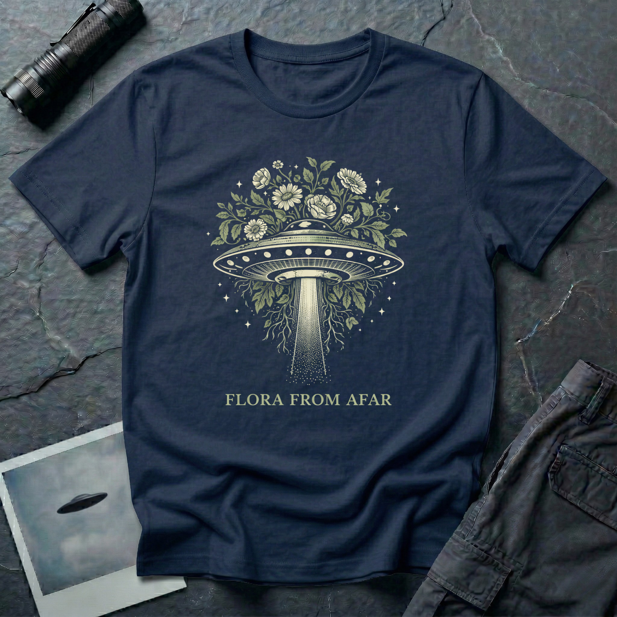 Flora From Afar botanical UFO t-shirt — Victorian-style flying saucer overgrown with flowers and vines in cream line-work on navy cotton tee