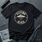 Black retro UFO t-shirt with a distressed circular badge design featuring a flying saucer and the words FLYING DISC in white