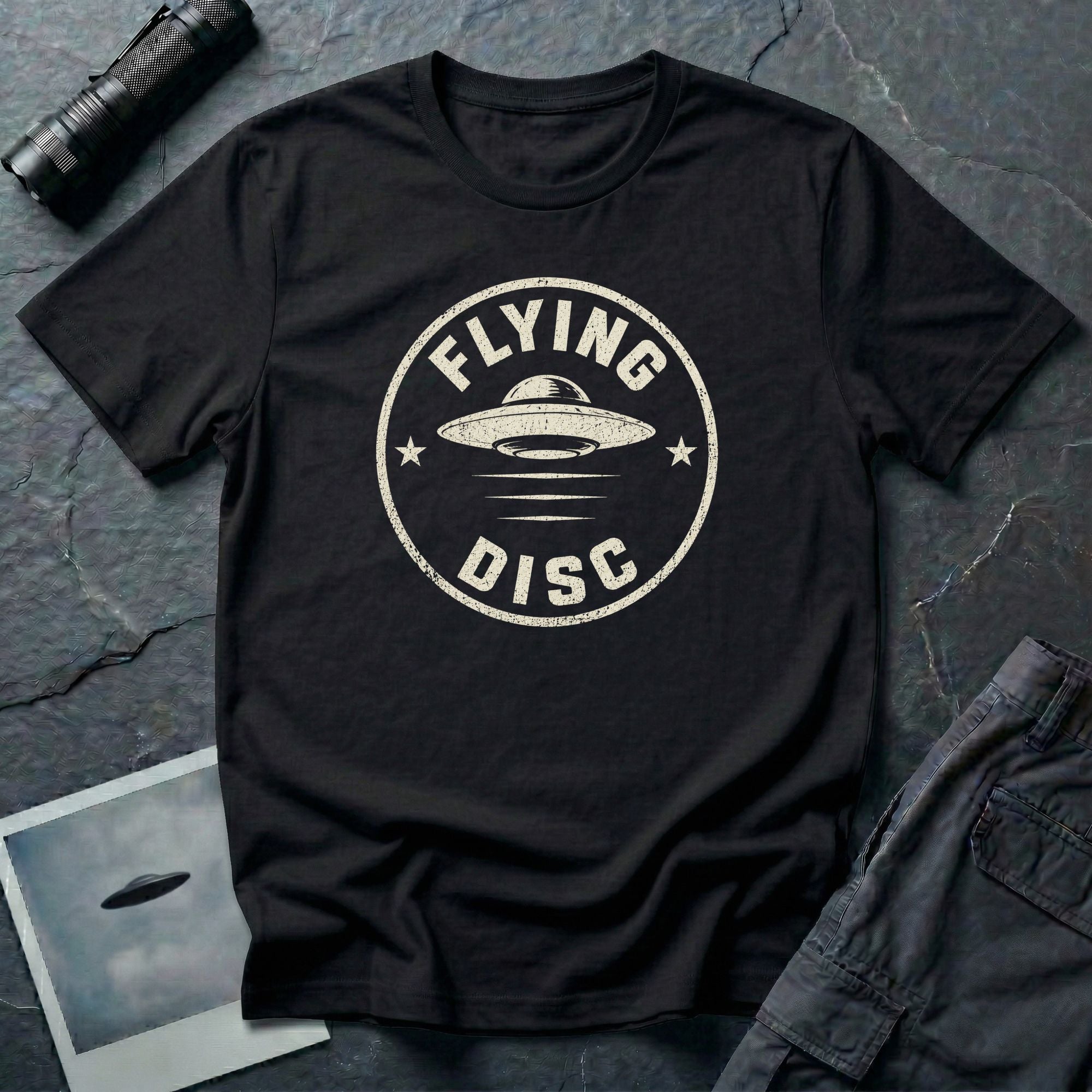 Black retro UFO t-shirt with a distressed circular badge design featuring a flying saucer and the words FLYING DISC in white