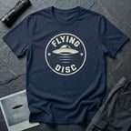 Navy blue retro UFO t-shirt with a distressed circular badge design featuring a flying saucer and the words FLYING DISC in white