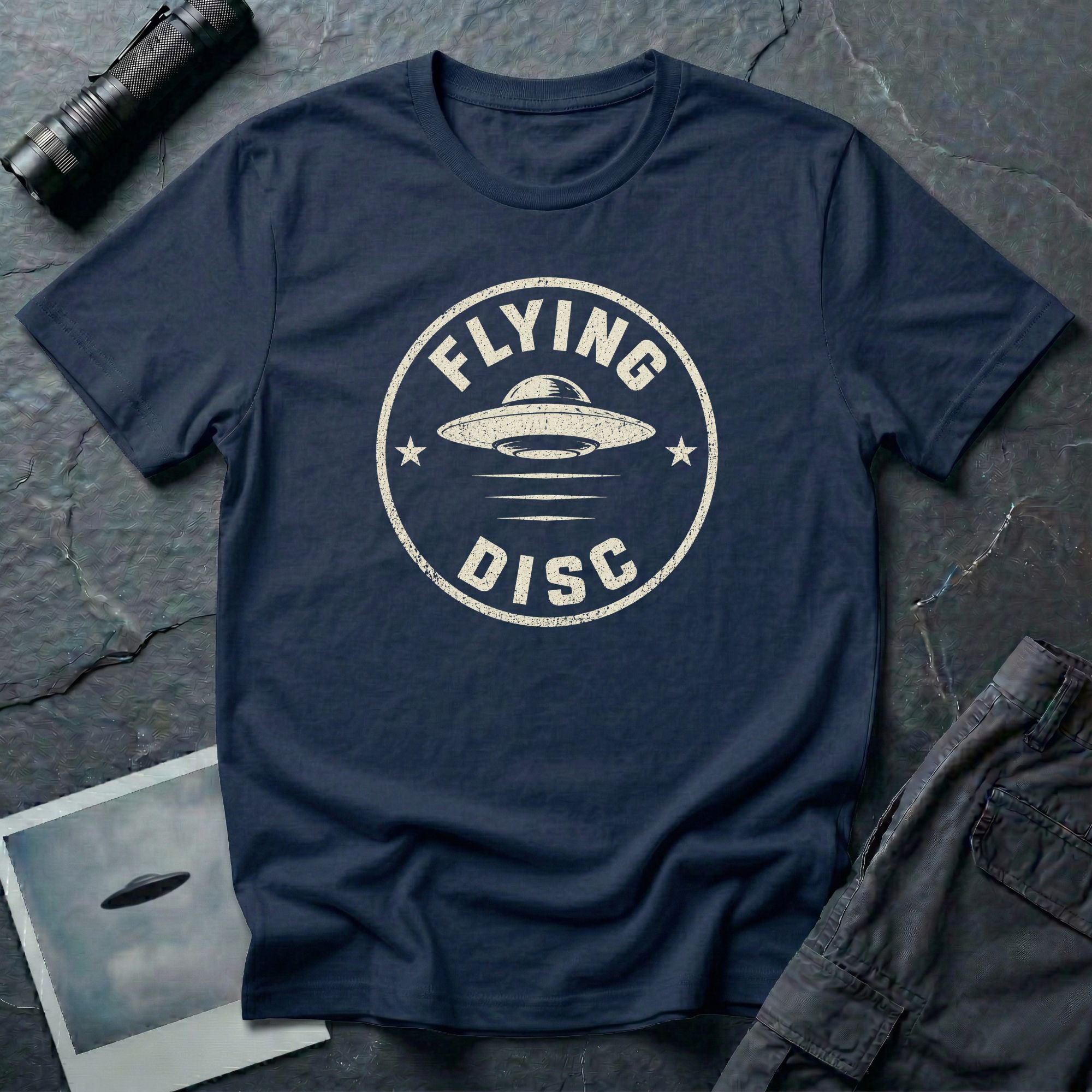 Navy blue retro UFO t-shirt with a distressed circular badge design featuring a flying saucer and the words FLYING DISC in white