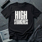 Black t-shirt with bold white High Strangeness text and small UFO above the lettering