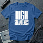 Royal blue t-shirt with bold white High Strangeness text and small UFO above the lettering