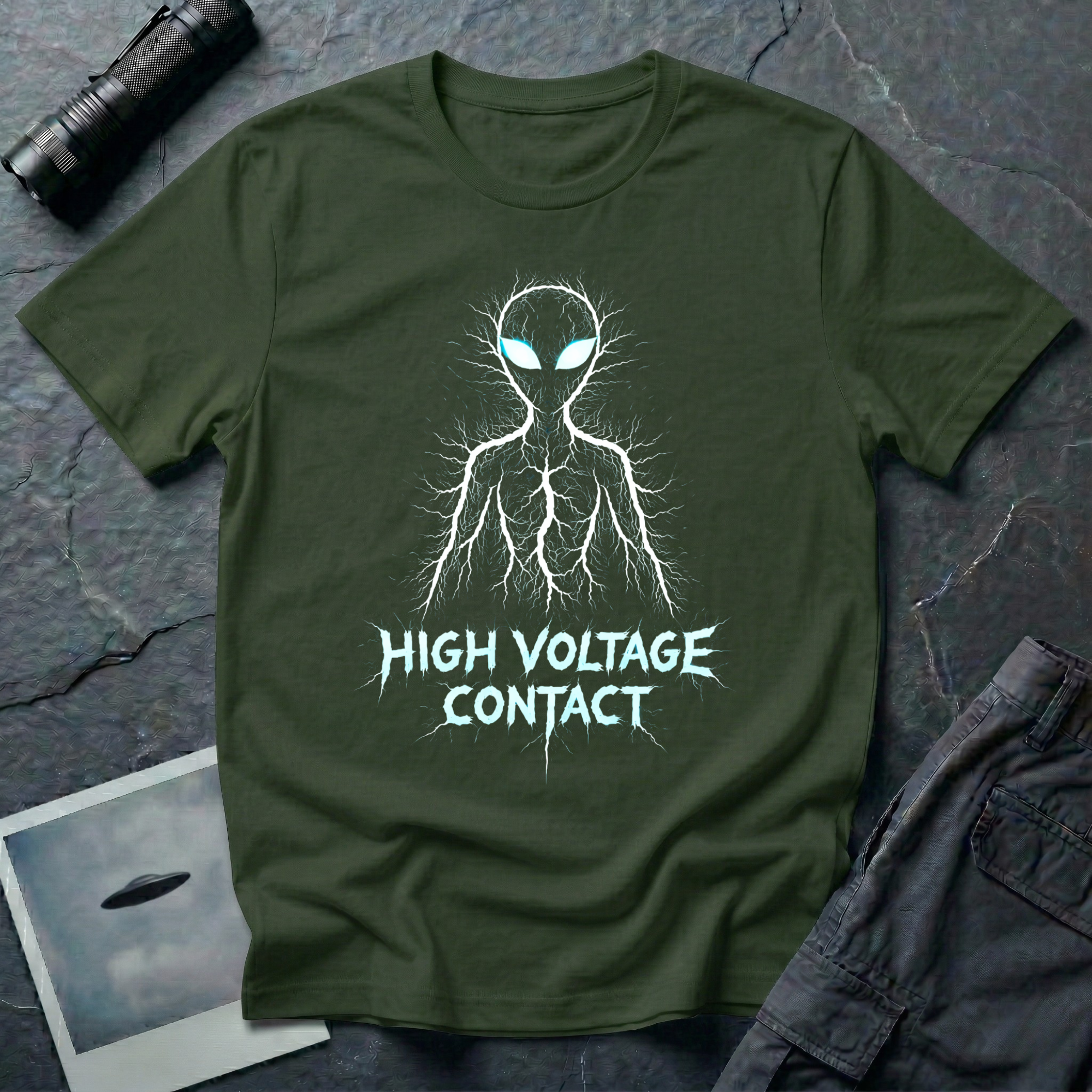High Voltage Contact electric alien t-shirt — grey alien figure formed from lightning branches with glowing cyan eyes and jagged "High Voltage Contact" text on green cotton tee
