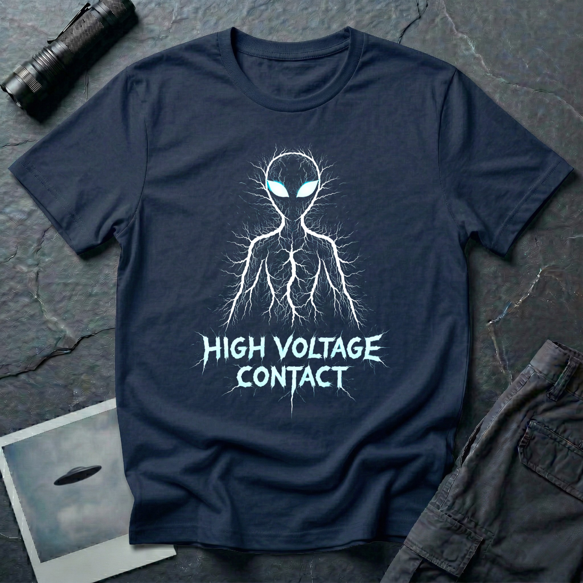High Voltage Contact electric alien t-shirt — grey alien figure formed from lightning branches with glowing cyan eyes and jagged "High Voltage Contact" text on navy cotton tee