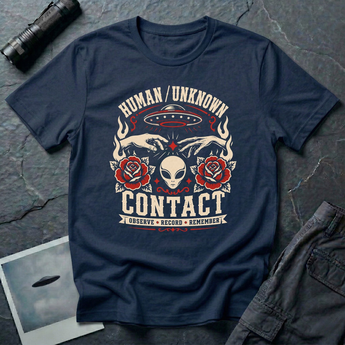 Navy blue t-shirt with traditional tattoo style alien head, roses, UFO, and reaching hands with Human Unknown Contact Observe Record Remember text
