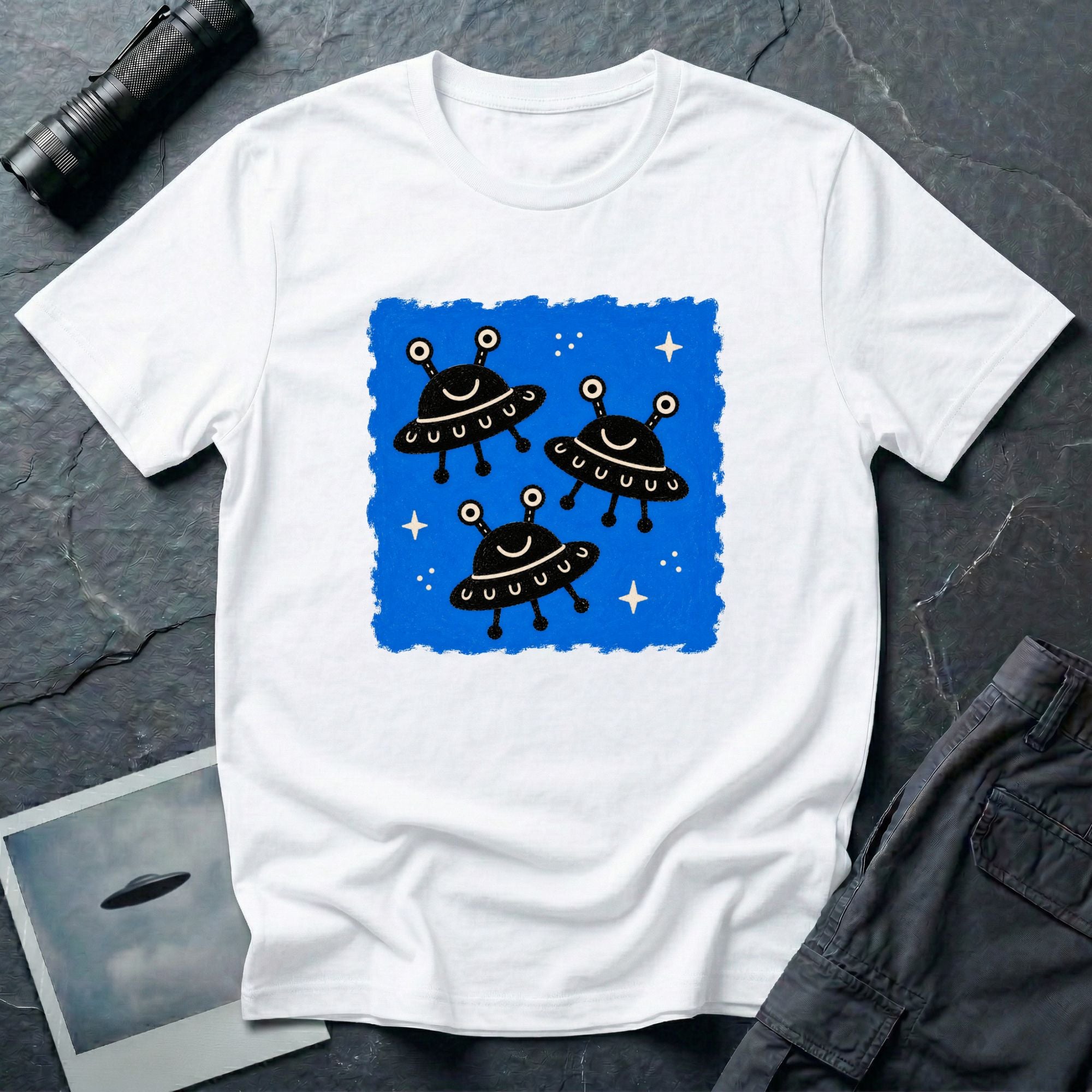 Little Visitors The Fleet UFO t-shirt with three smiling black saucers in formation on blue
