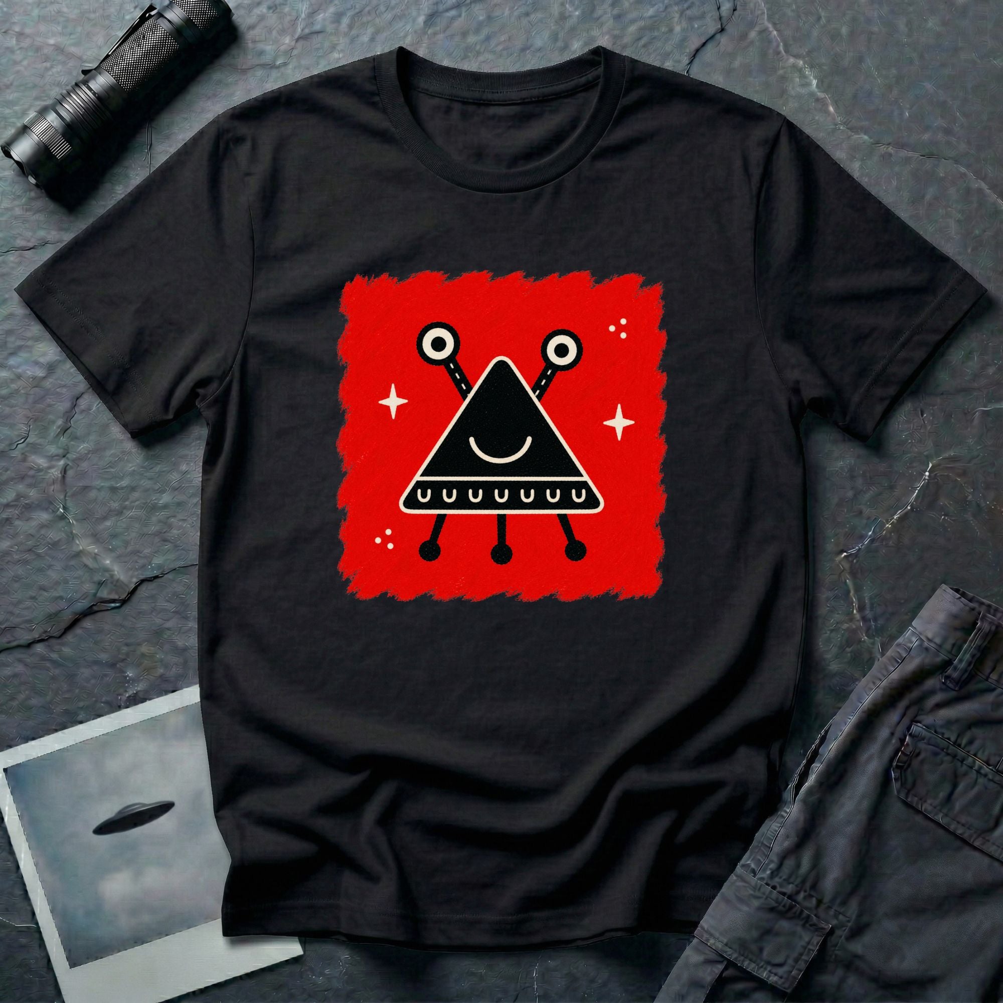 Little Visitors The Triangle UFO t-shirt with smiling black triangle craft on red, black shirt