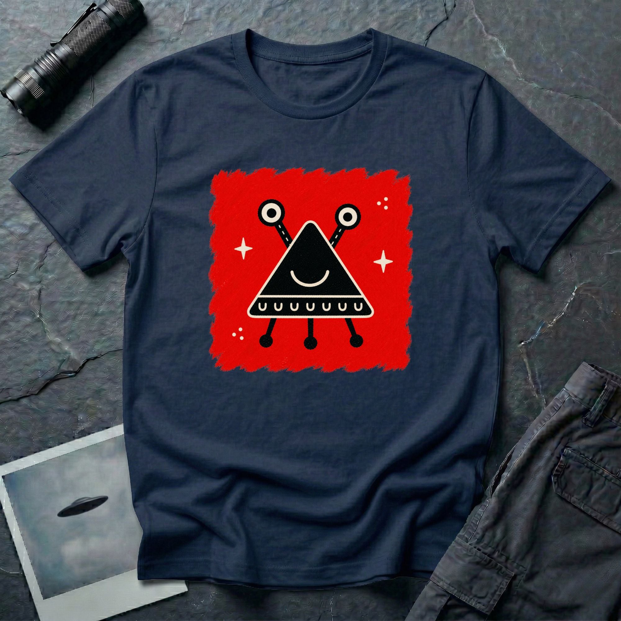 Little Visitors The Triangle UFO t-shirt with smiling black triangle craft on red, navy blue shirt
