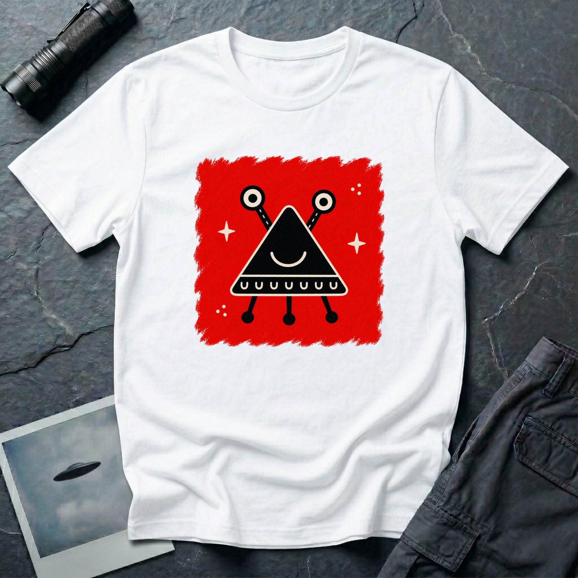Little Visitors The Triangle UFO t-shirt with smiling black triangle craft on red, white shirt