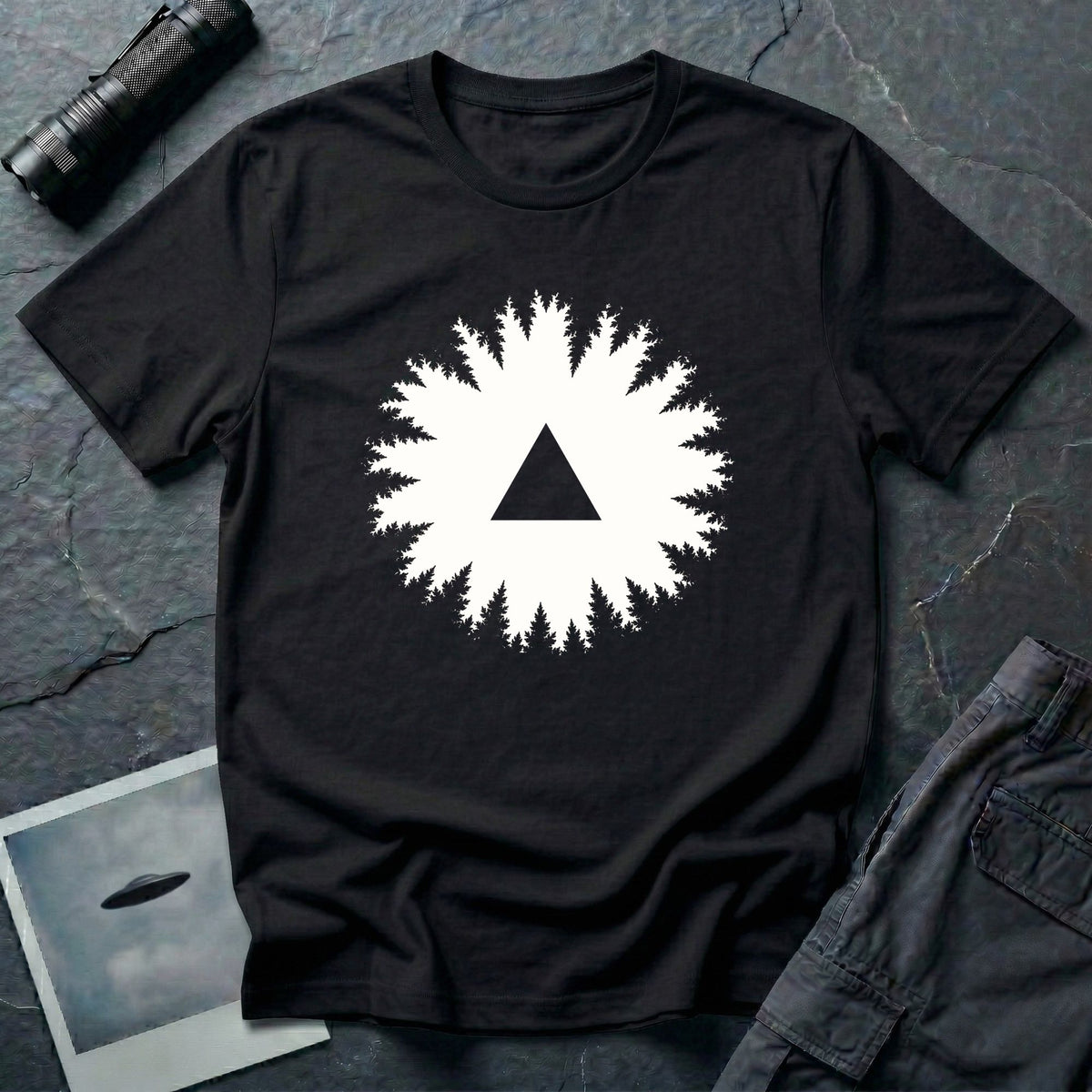 Black triangle UFO t-shirt, view looking straight up through a ring of forest treetops at a black triangular craft against ivory sky, black