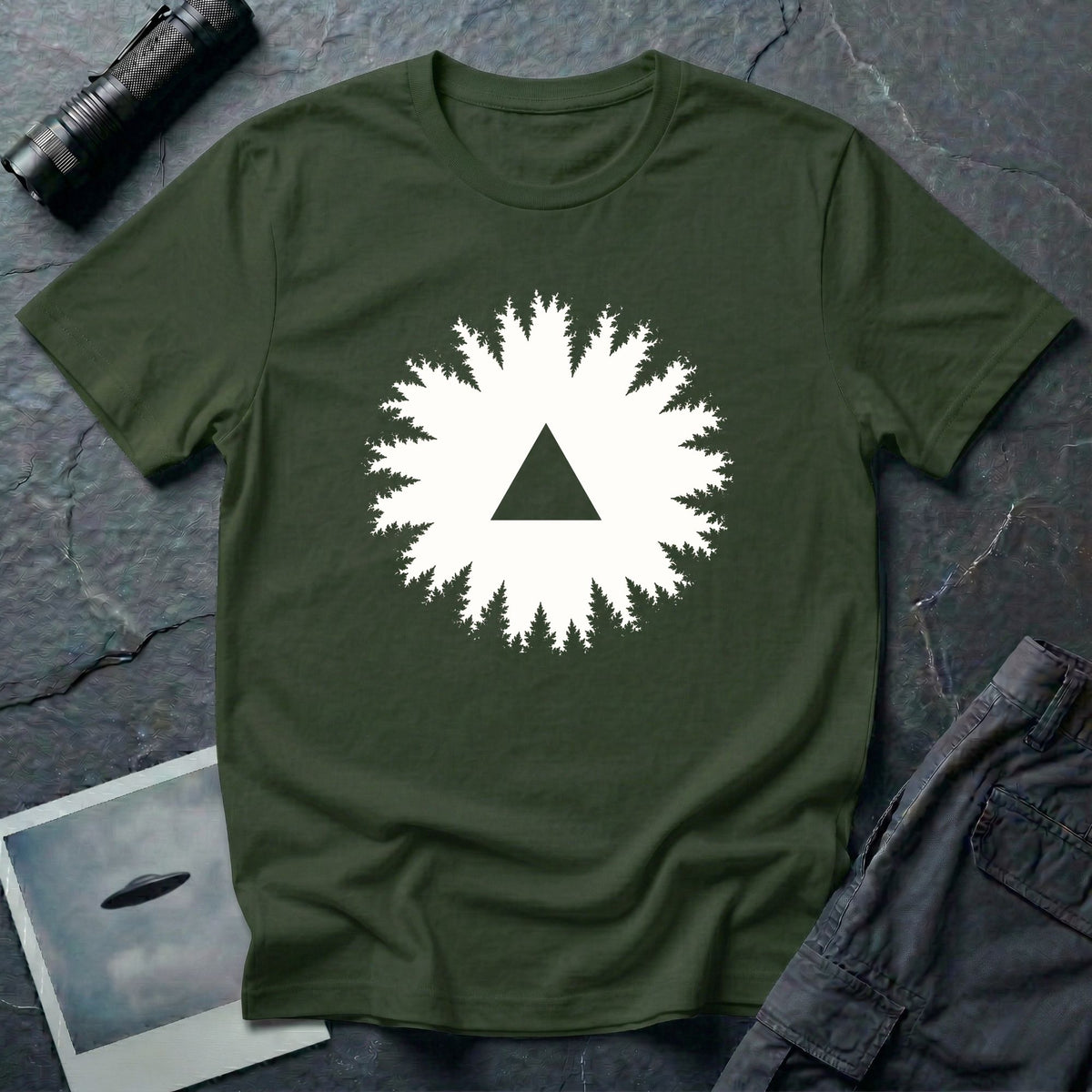 Black triangle UFO t-shirt, view looking straight up through a ring of forest treetops at a black triangular craft against ivory sky, military green