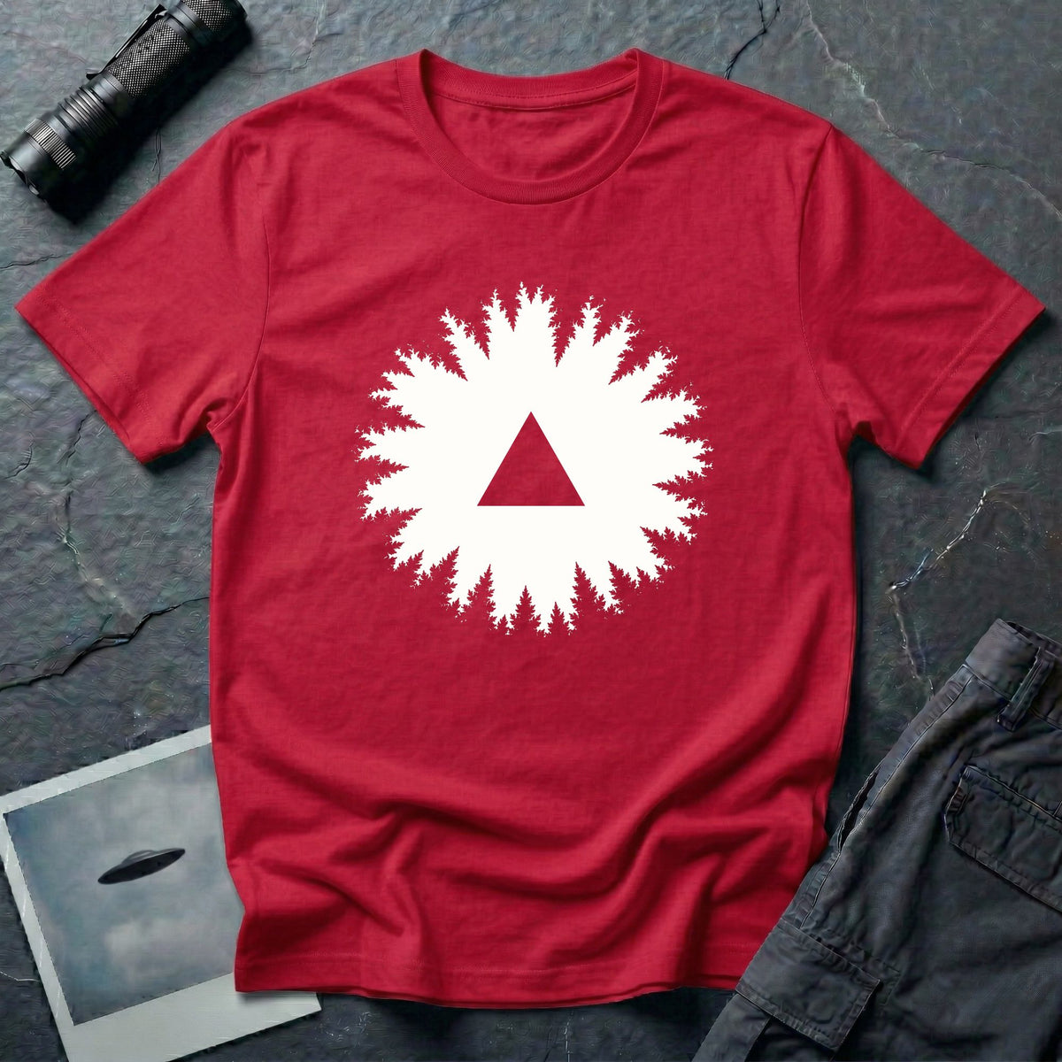 Black triangle UFO t-shirt, view looking straight up through a ring of forest treetops at a black triangular craft against ivory sky, red