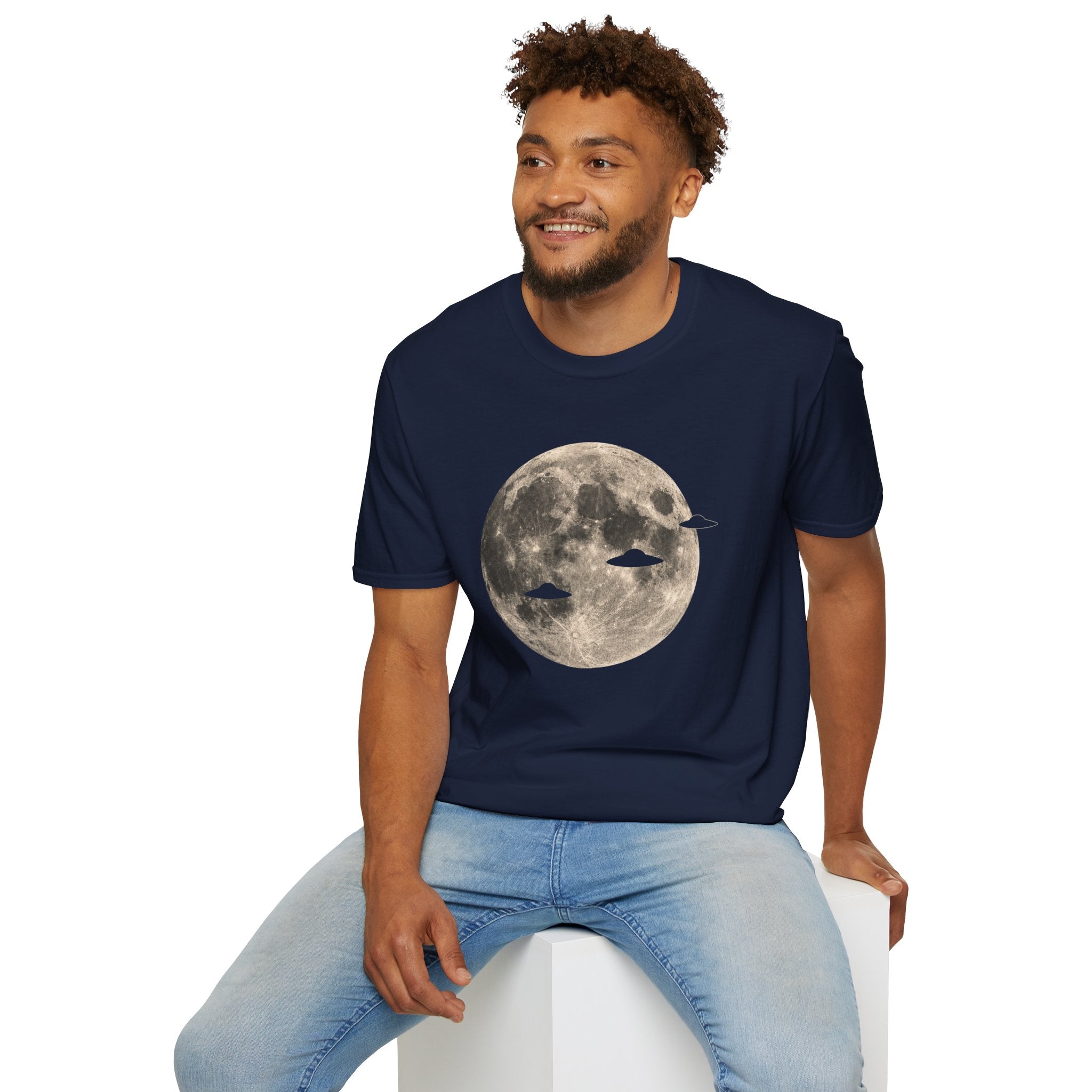 Man wearing a UFO t-shirt with three disc silhouettes crossing a full moon photograph
