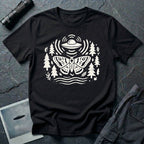 Moth and UFO T-shirt with a folk-art moth beneath a flying saucer, surrounded by pine trees, leaves and radiating signal lines, on black t-shirt