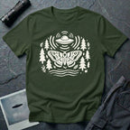 Moth and UFO T-shirt with a folk-art moth beneath a flying saucer, surrounded by pine trees, leaves and radiating signal lines, on military green t-shirt