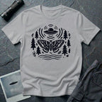 Moth and UFO T-shirt with a folk-art moth beneath a flying saucer, surrounded by pine trees, leaves and radiating signal lines, on sport grey t-shirt