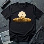 T-shirt with gold engraved mountain range under a moon and UFO with Mountain Return Cascades 1947 caption, black