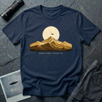 T-shirt with gold engraved mountain range under a moon and UFO with Mountain Return Cascades 1947 caption, navy blue