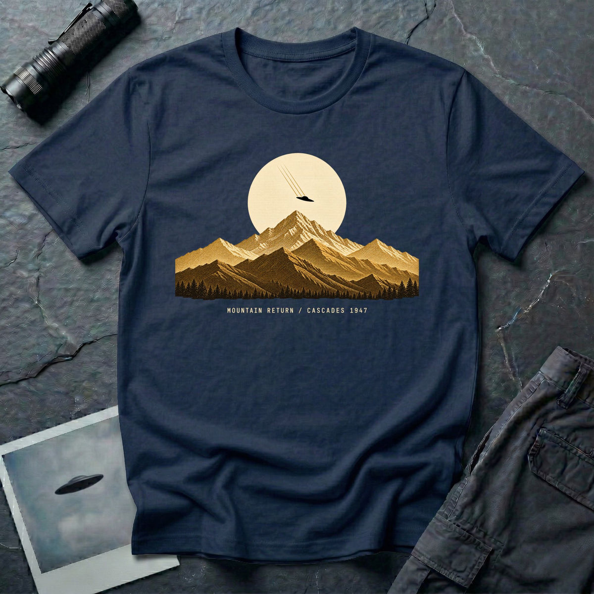 T-shirt with gold engraved mountain range under a moon and UFO with Mountain Return Cascades 1947 caption, navy blue