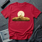 T-shirt with gold engraved mountain range under a moon and UFO with Mountain Return Cascades 1947 caption, red
