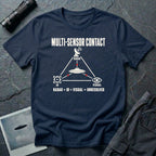 Radar dish, targeting reticle, and eye icon forming a triangle around a UFO with Multi-Sensor Contact text on a navy blue t-shirt