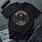 Black retro UFO t-shirt with a distressed circular badge showing a flying saucer over a desert landscape with cacti and the words MYSTERY LIGHT in gold