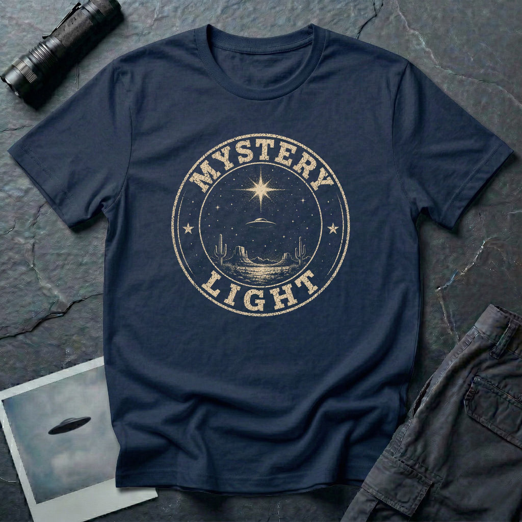 Navy blue retro UFO t-shirt with a distressed circular badge showing a flying saucer over a desert landscape with cacti and the words MYSTERY LIGHT in gold