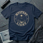 Navy blue retro UFO t-shirt with a distressed circular badge showing a flying saucer over a desert landscape with cacti and the words MYSTERY LIGHT in gold