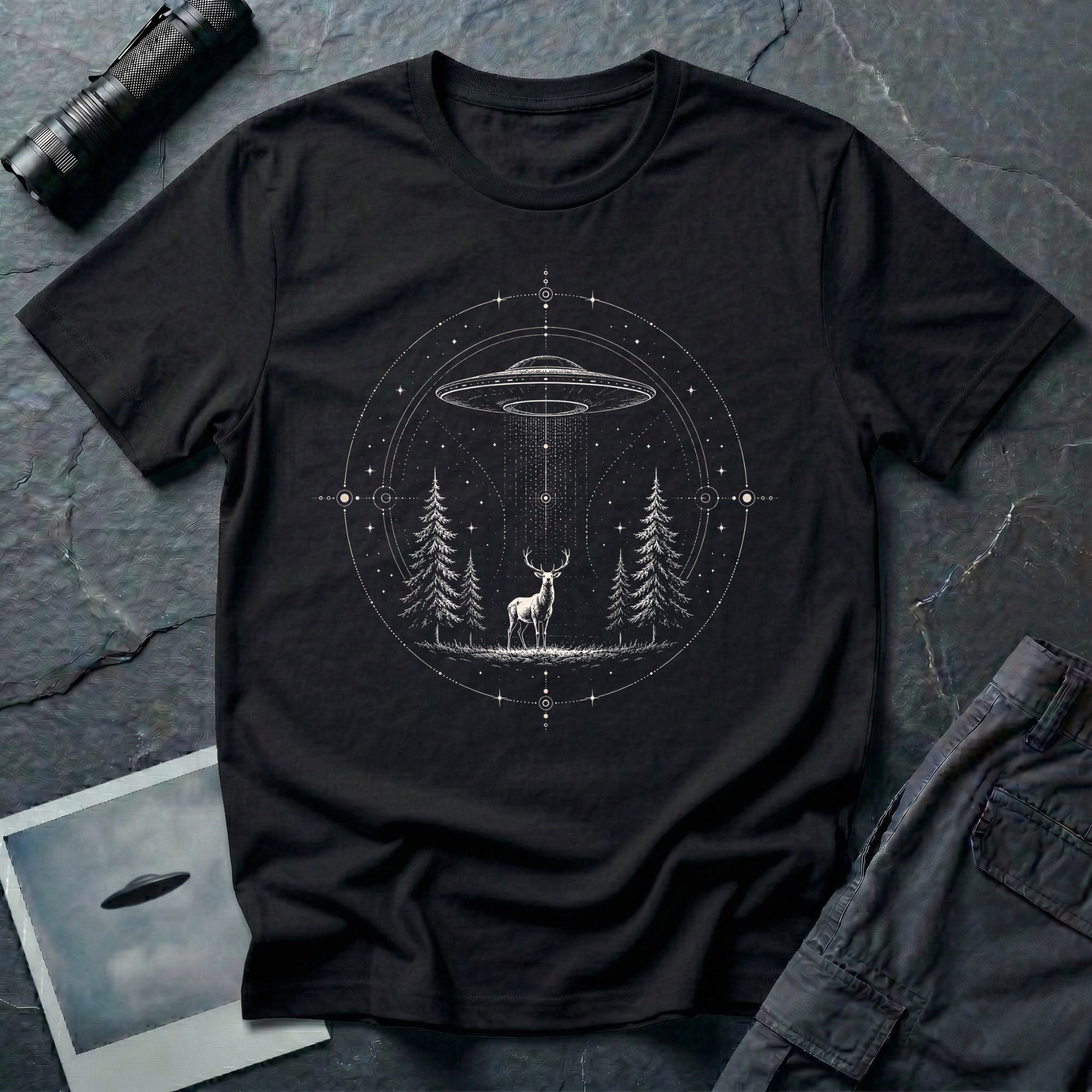 Mystical Stag UFO black T-Shirt featuring a stag under a hovering saucer in a pine forest with stars and sacred geometric details