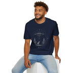 Man in Mystical Stag navy blue UFO T-Shirt featuring a stag under a hovering saucer in a pine forest with stars and sacred geometric details