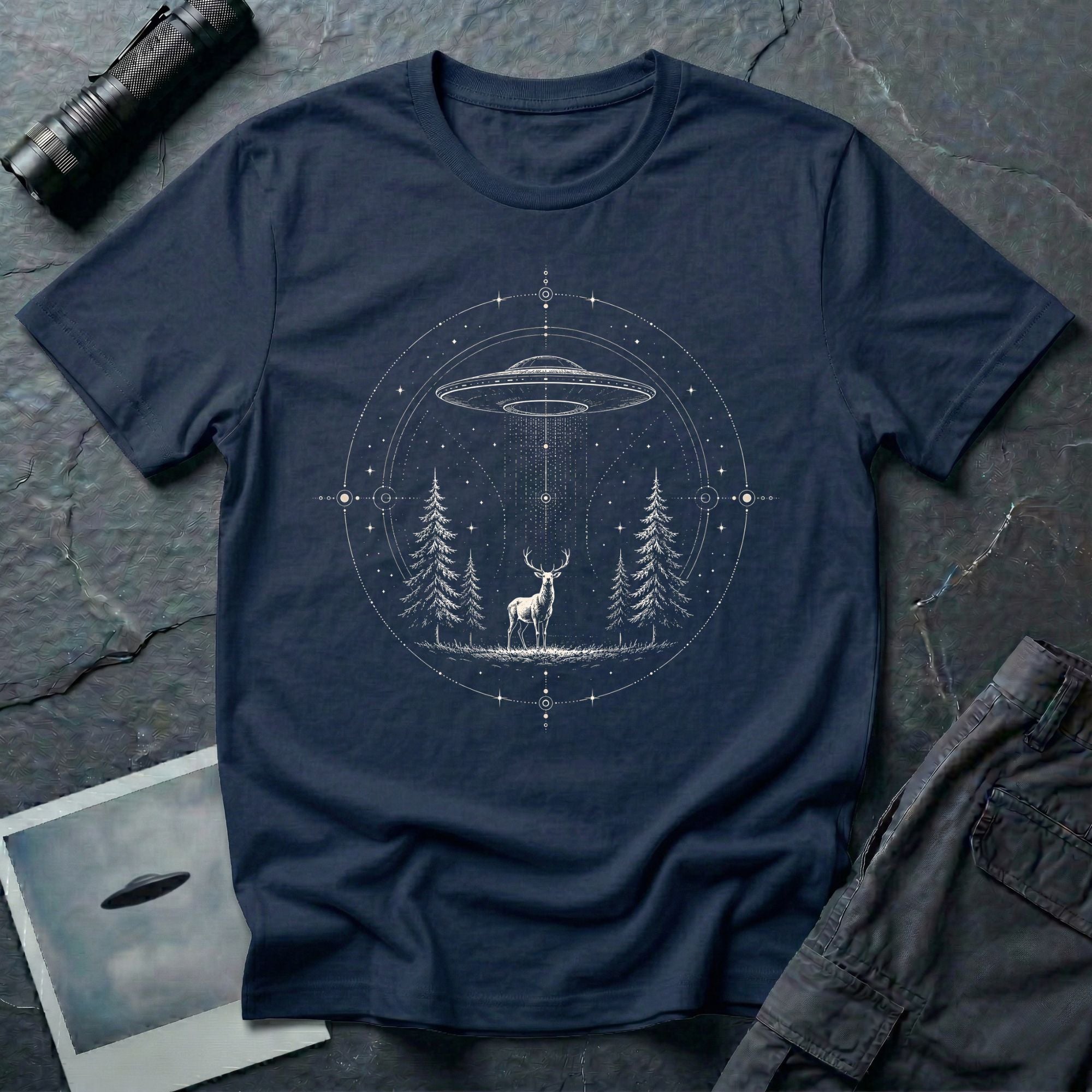 Mystical Stag UFO navy blue T-Shirt featuring a stag under a hovering saucer in a pine forest with stars and sacred geometric details