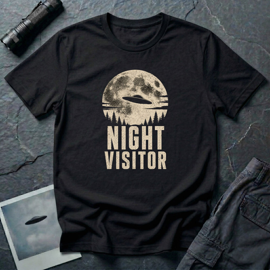 Black retro UFO t-shirt with a flying saucer crossing a full moon over a conifer treeline with the words NIGHT VISITOR in distressed pale lettering