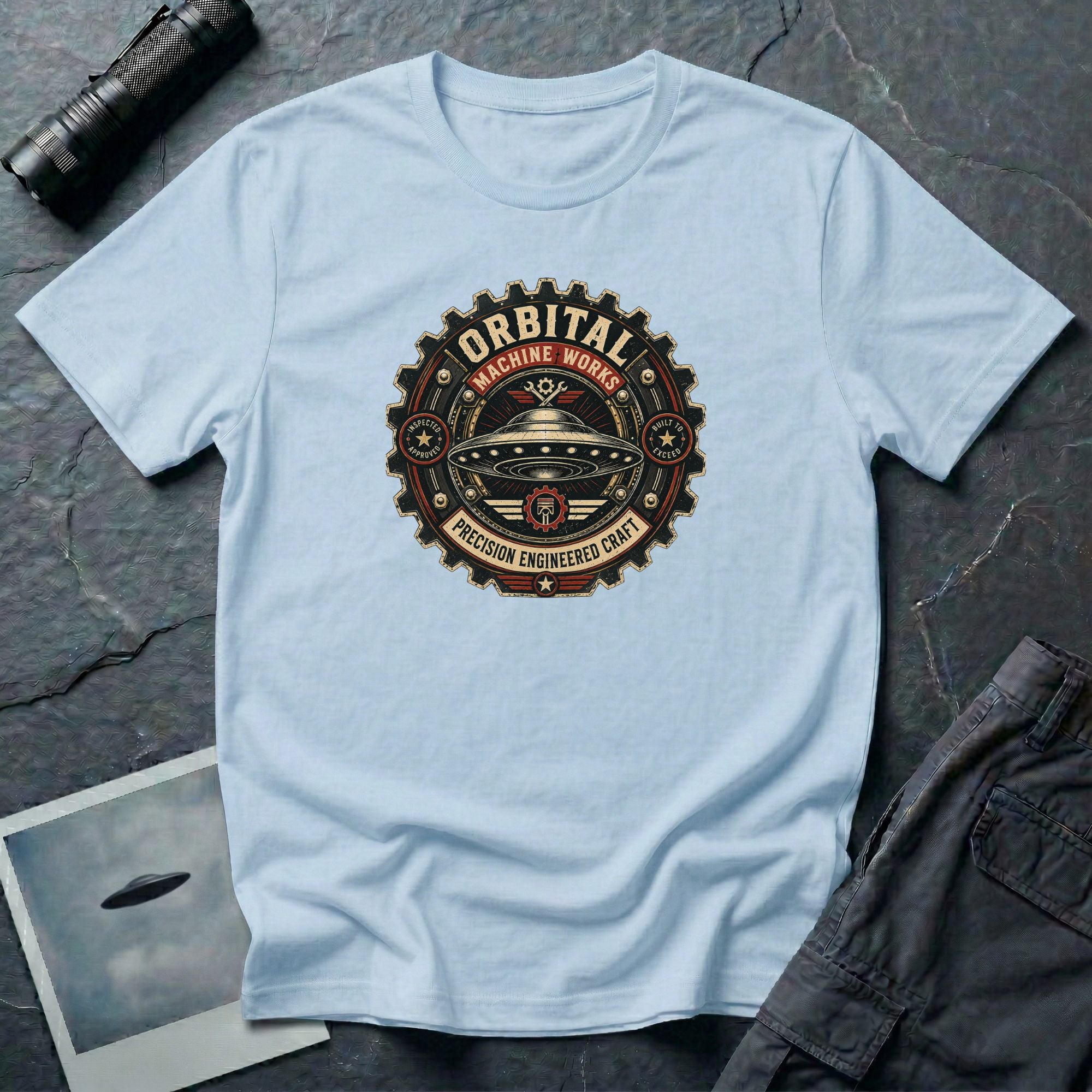 Orbital Machine Works UFO patch t-shirt with riveted saucer in vintage gear wheel emblem, light blue