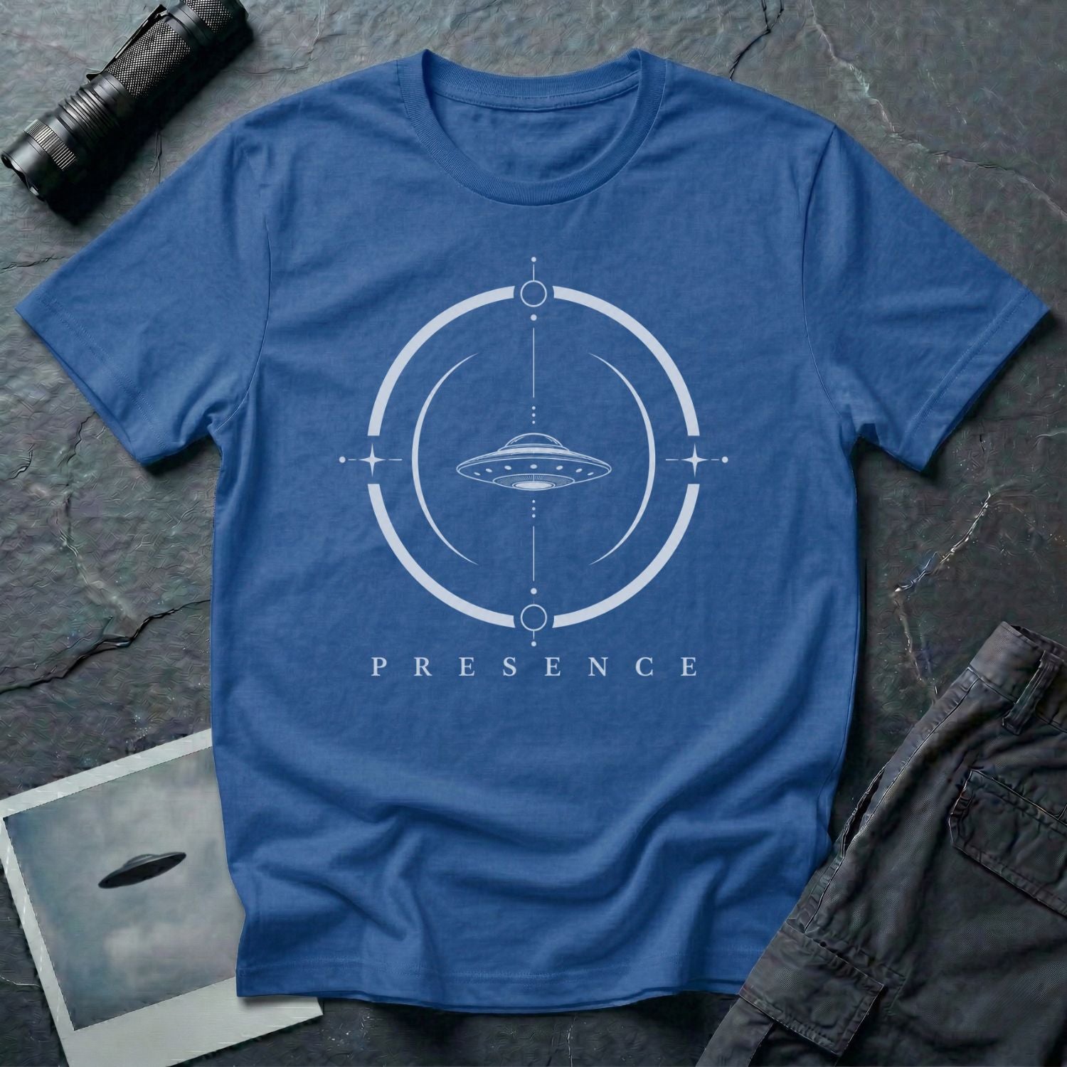 Royal blue UFO t-shirt with a flying saucer inside a broken circular frame with the word PRESENCE beneath