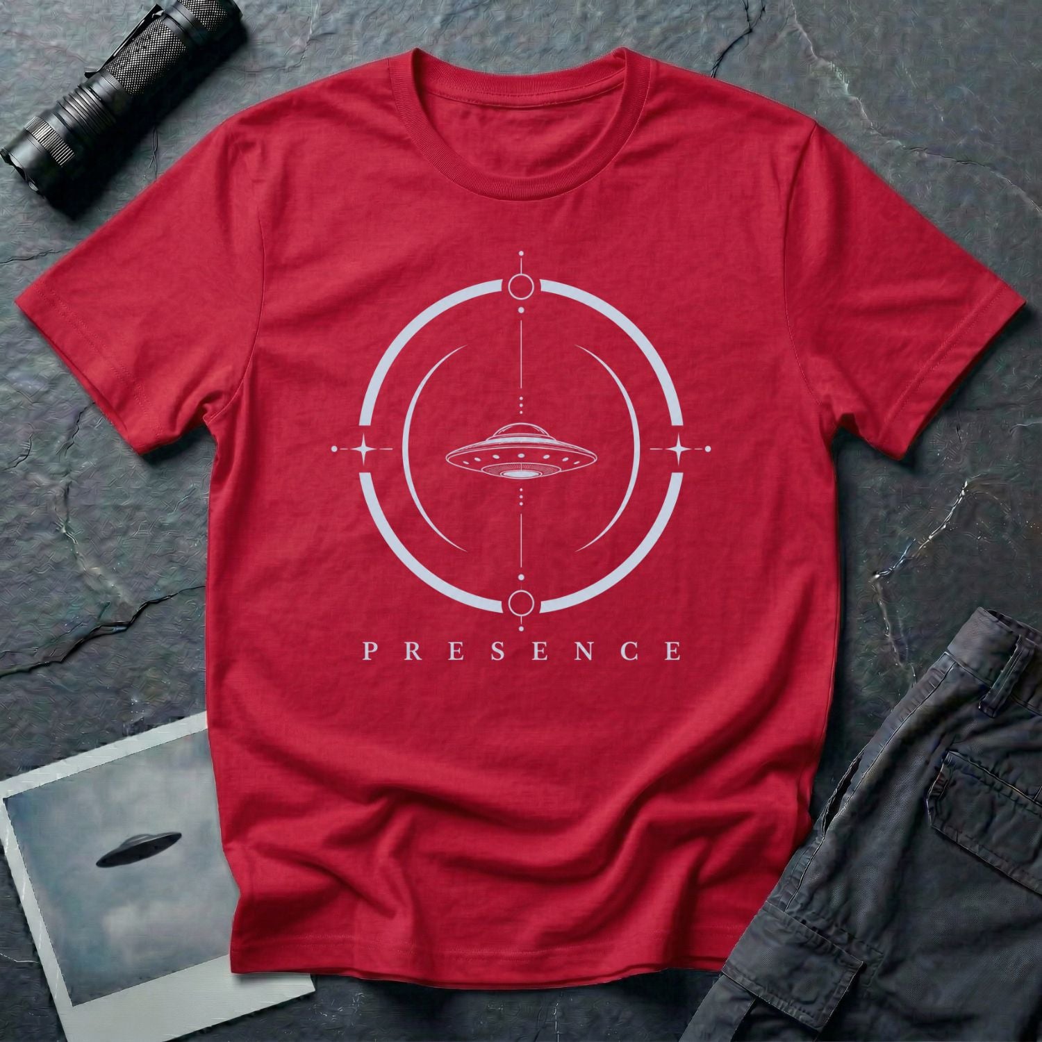 Red UFO t-shirt with a flying saucer inside a broken circular frame with the word PRESENCE beneath