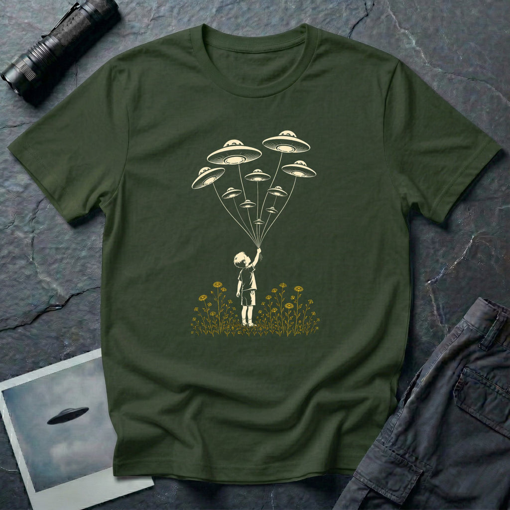 Stencil UFO t-shirt design, child reaching up to hold strings tethered to a small fleet of UFOs, orange wildflowers at the base, green tee