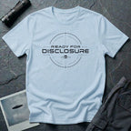 Light blue UFO disclosure t-shirt with a targeting reticle crosshair and the words READY FOR DISCLOSURE in black tech typography with a small flying saucer