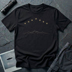 Black t-shirt with arc of gold light formation above minimalist mountain range line art