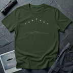 Military green t-shirt with arc of gold light formation above minimalist mountain range line art