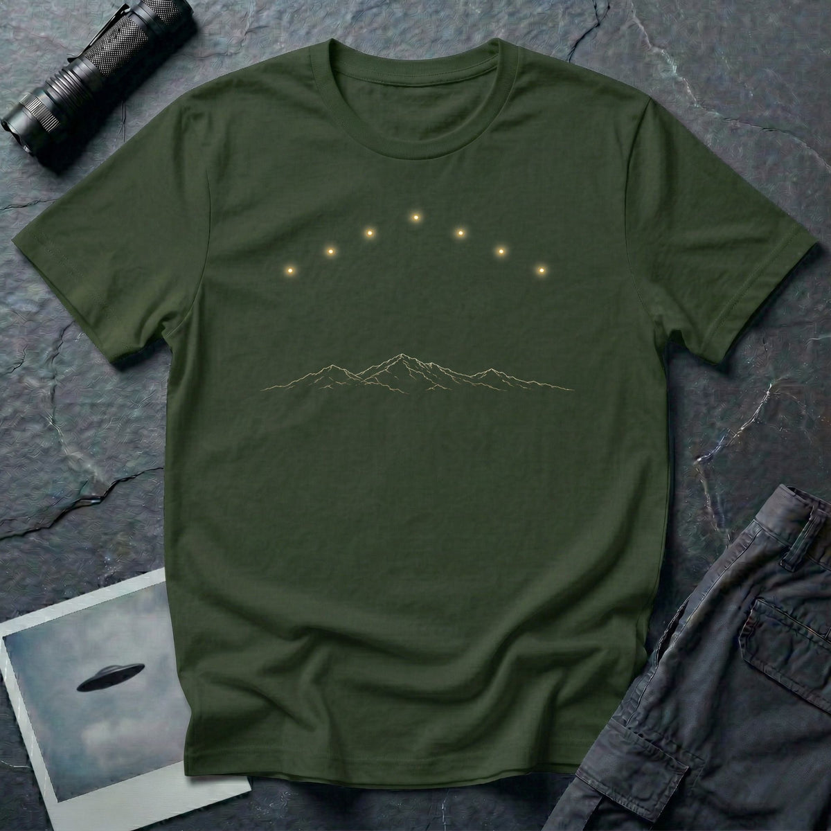 Military green t-shirt with arc of gold light formation above minimalist mountain range line art