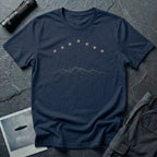 Navy blue t-shirt with arc of gold light formation above minimalist mountain range line art