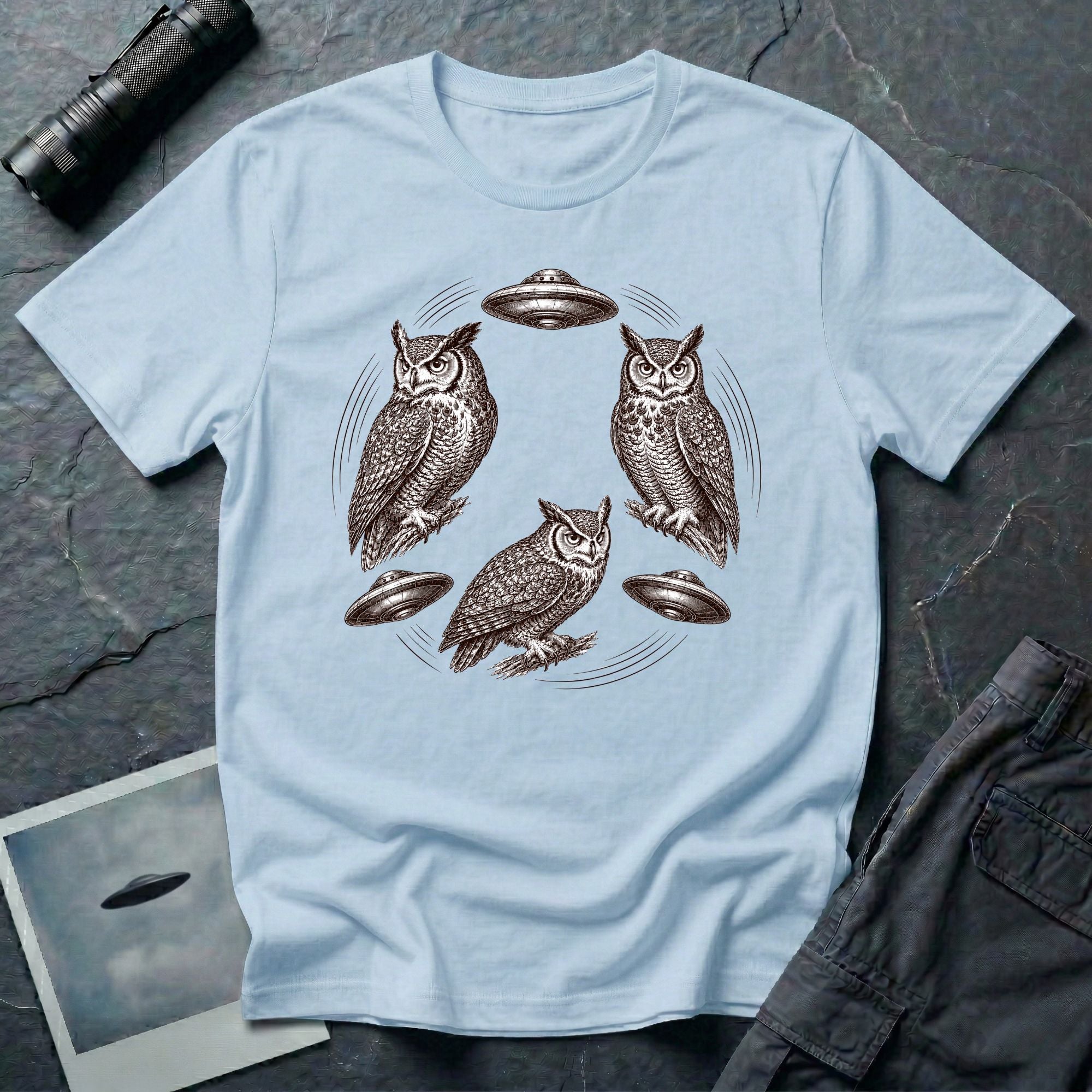 Silent Wings Owl UFO t-shirt with three engraved owls and three saucers in a circular design, light blue