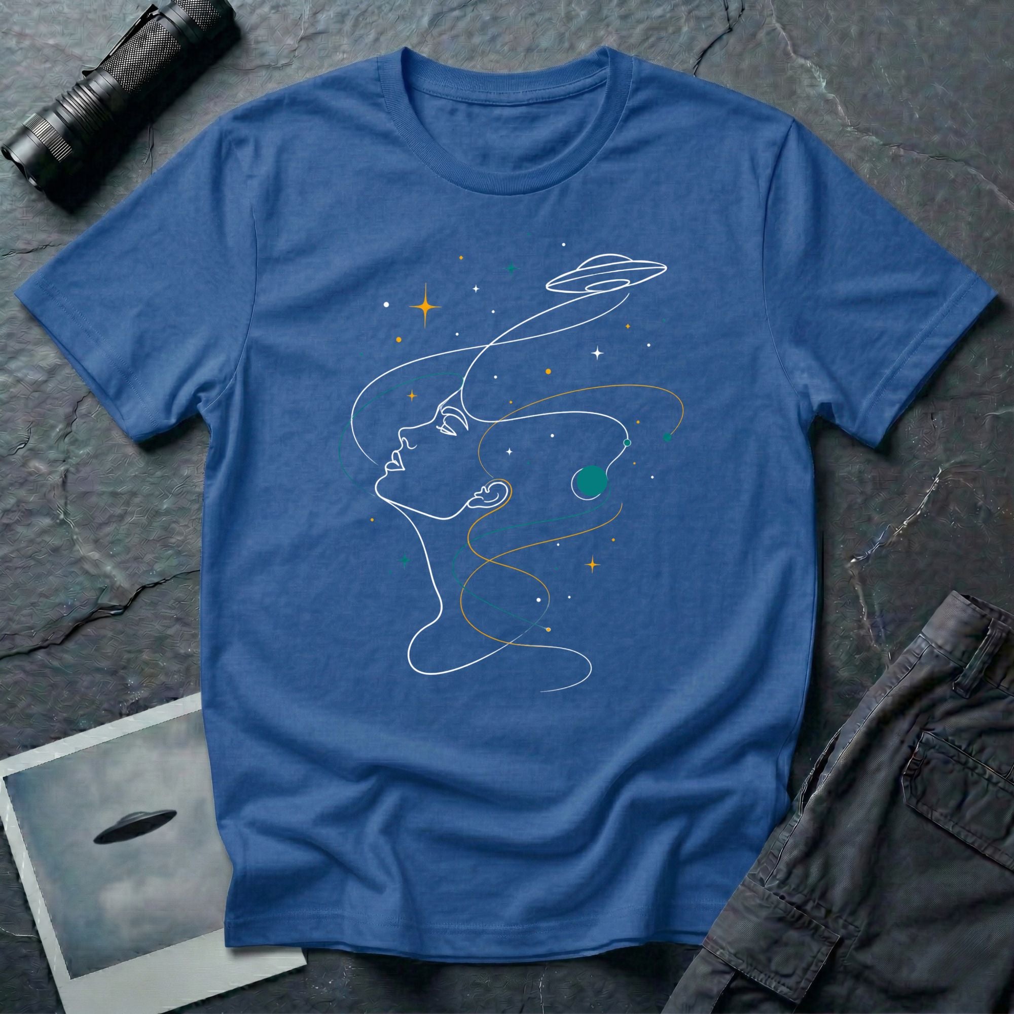 Sky Dreamer UFO t-shirt with single-line art of a woman gazing up at a saucer with stars, blue