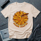 Solar Eclipse retro UFO t-shirt — smiling 1970s sun with flying saucer photobombing on natural unisex cotton tee