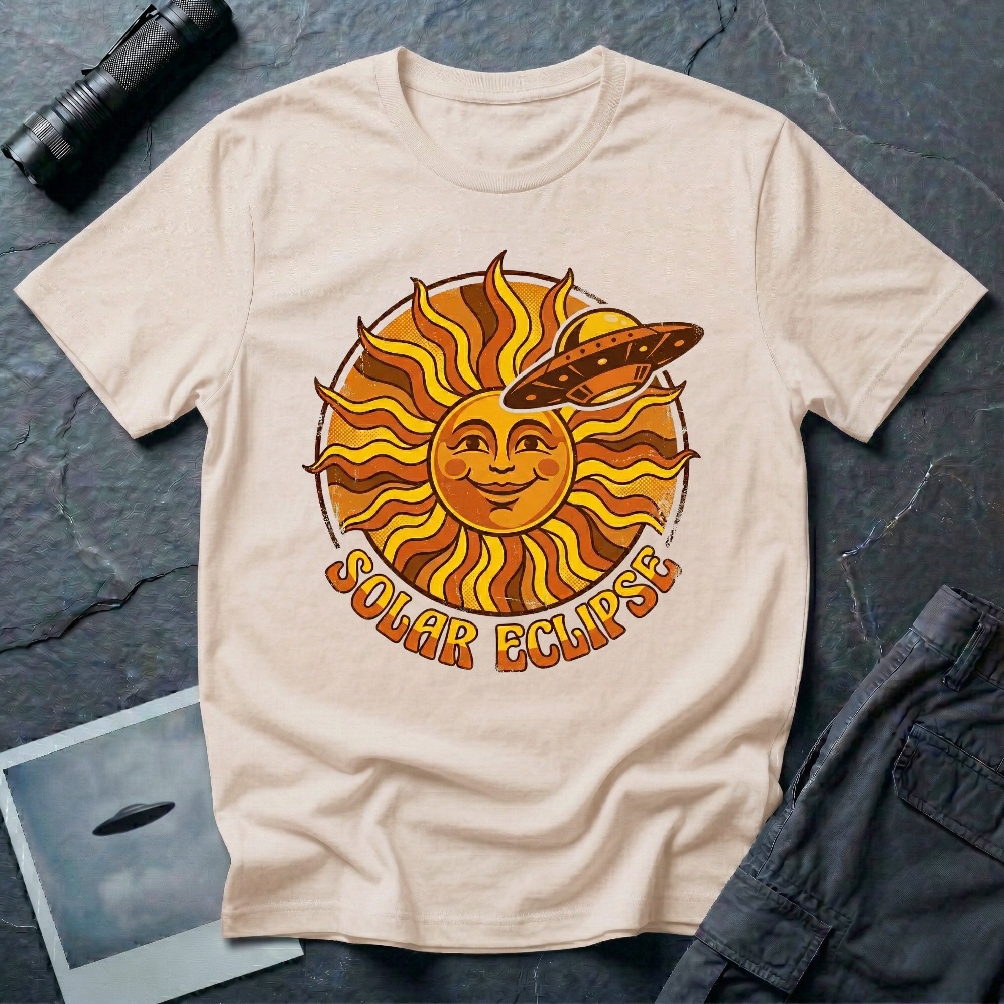 Solar Eclipse retro UFO t-shirt — smiling 1970s sun with flying saucer photobombing on natural unisex cotton tee