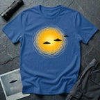 Solar Fly-by artistic UFO t-shirt — three black flying saucers passing across a glowing sun on blue unisex cotton tee