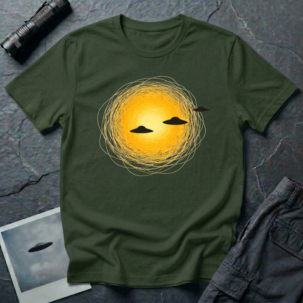 Solar Fly-by artistic UFO t-shirt — three black flying saucers passing across a glowing sun on military green unisex cotton tee